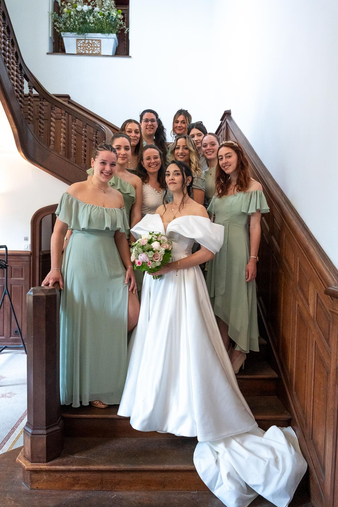 La mariée entourée de ses témoins sur un escalier en bois