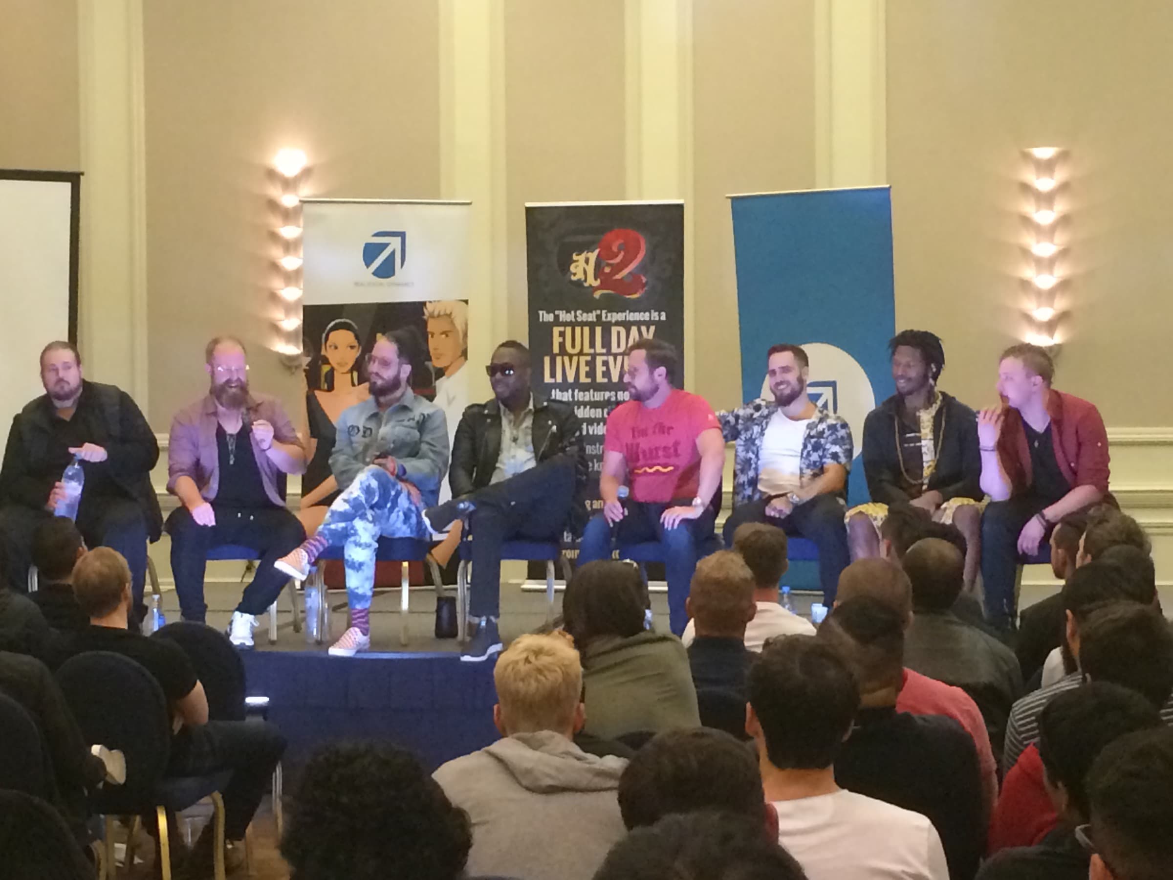 Panel of speakers on stage during a networking event