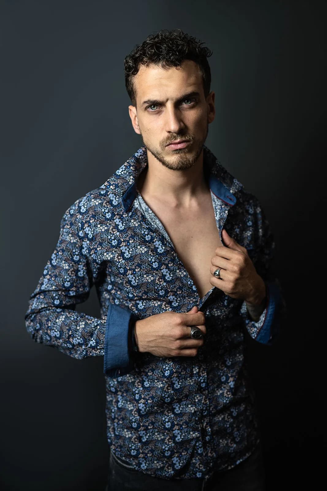 Homme en chemise fleurie entrouverte, en studio